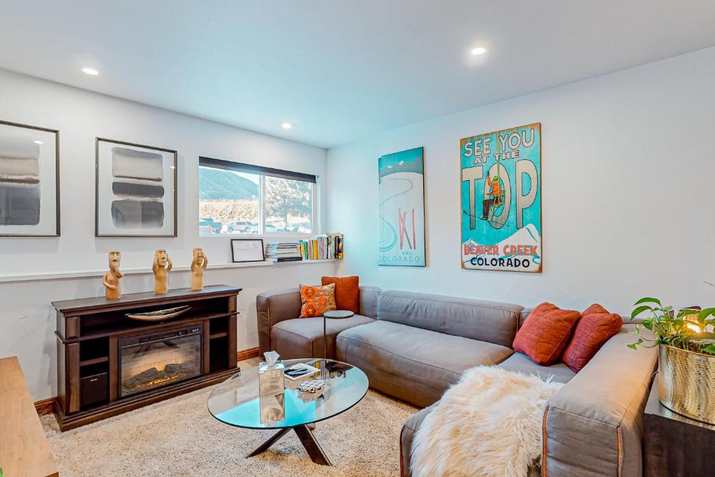 a living room with a couch and a fireplace at Modern Ski Retreat #C7 in Avon