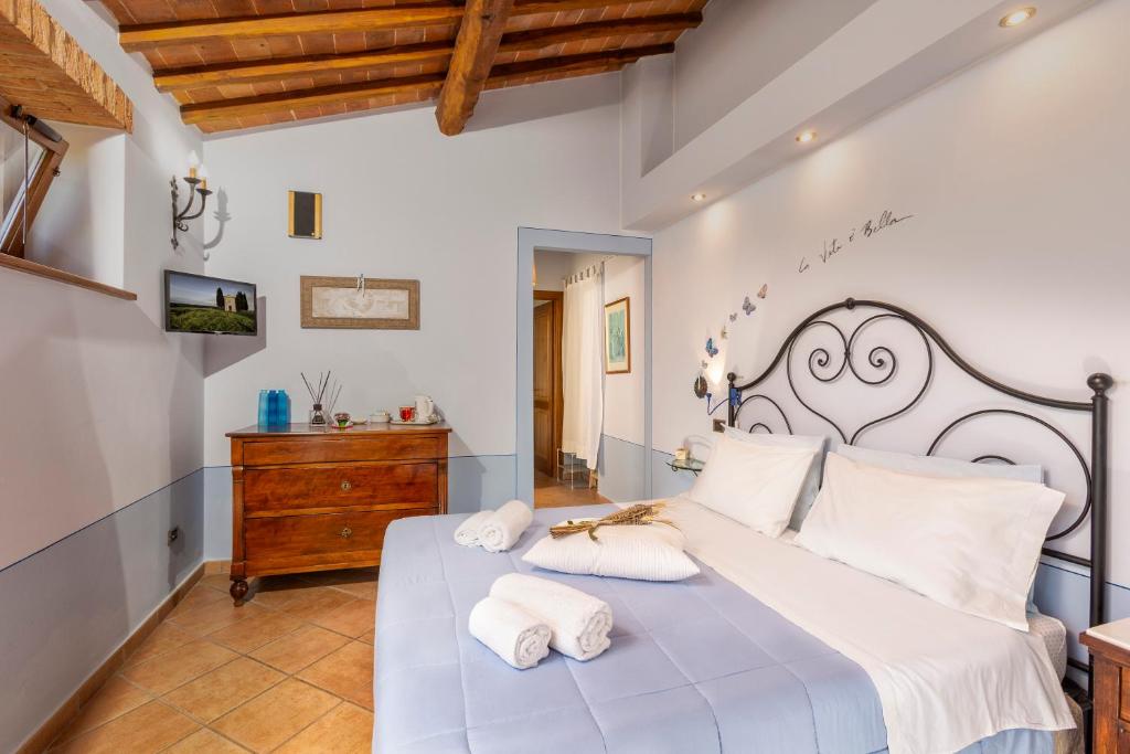 a bedroom with a large white bed with towels on it at B&B La Casa di Assunta in Acquaviva