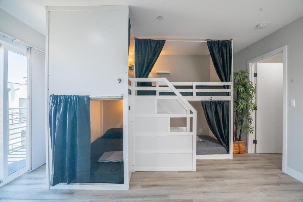a bedroom with a bunk bed in a room at Normandie Hostel in Los Angeles