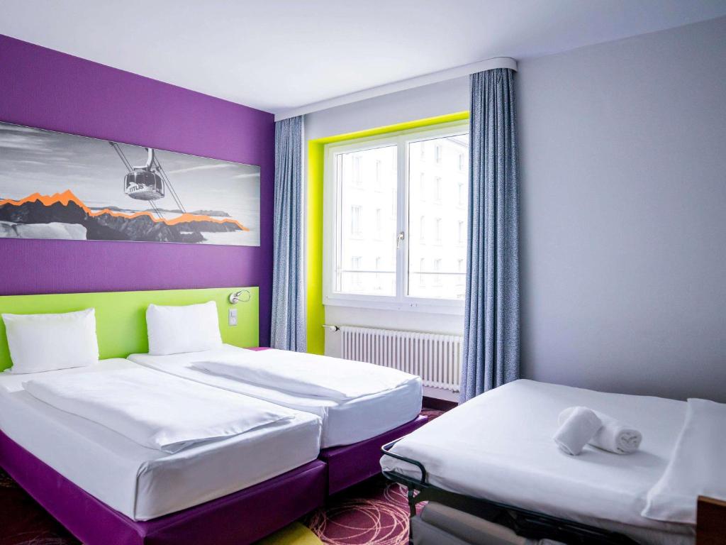 Postel nebo postele na pokoji v ubytování ibis Styles Luzern