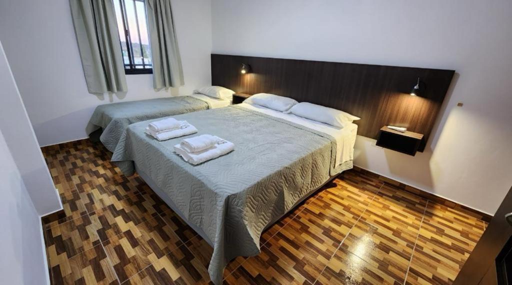 a bedroom with two beds with towels on them at Las Calas in Puerto Rico