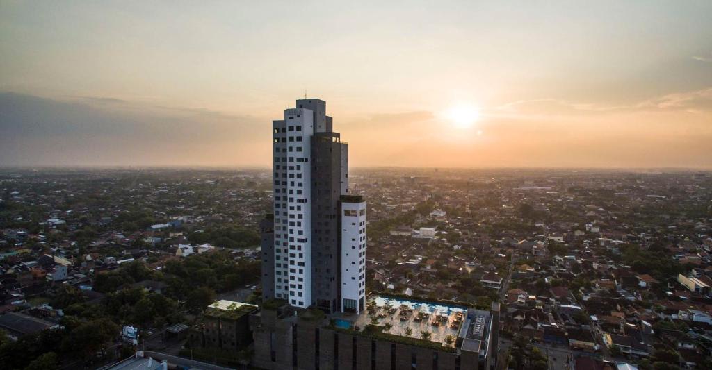 a tall building in a city at sunset at Alila Solo in Solo