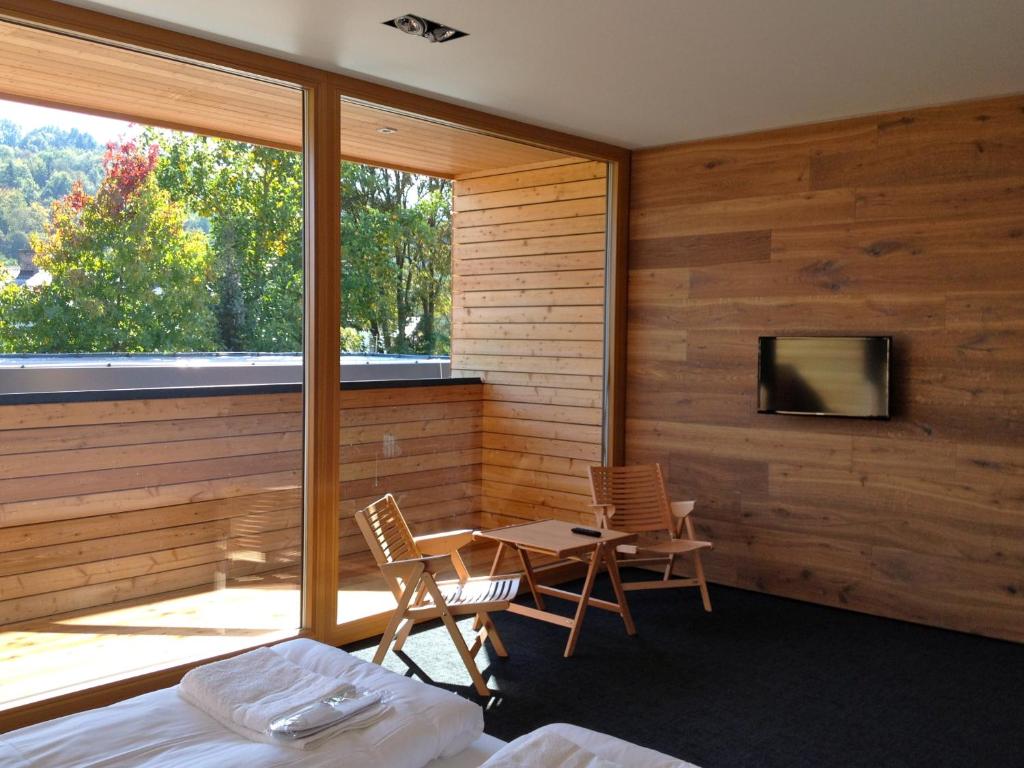 a bedroom with a bed and a table and chairs at Guest House Hiša Denk in Zgornja Kungota