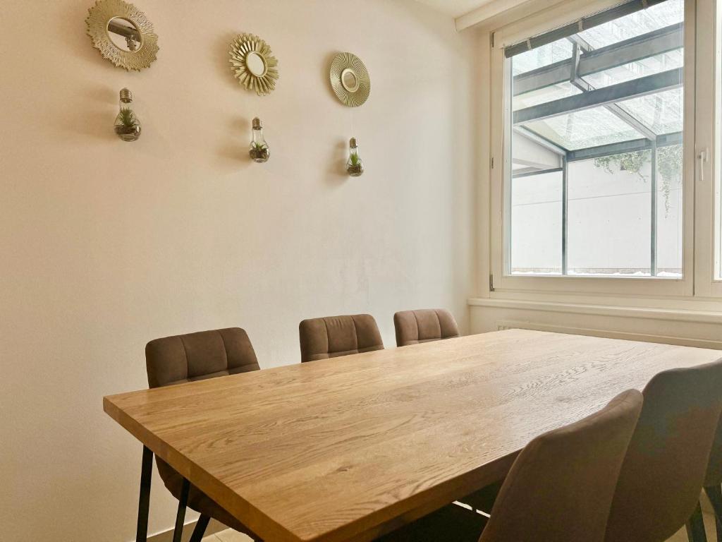 a dining room table with chairs and a window at 90 m2 Maisonette with Free Parking in Vienna