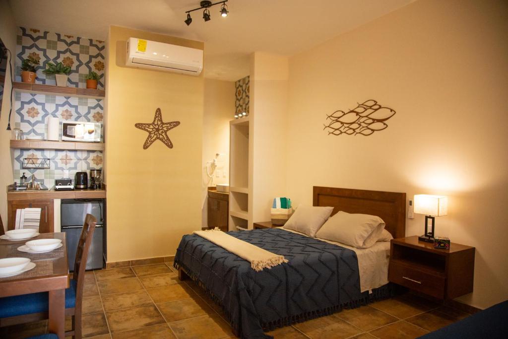 a bedroom with a bed and a room with a table at Estancia 103 in La Paz