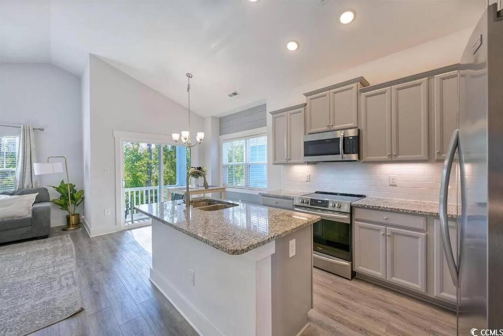 a kitchen with a large counter top in a room at Brand New Home 3 Bed 25 bath, 4min walk to beach in Myrtle Beach