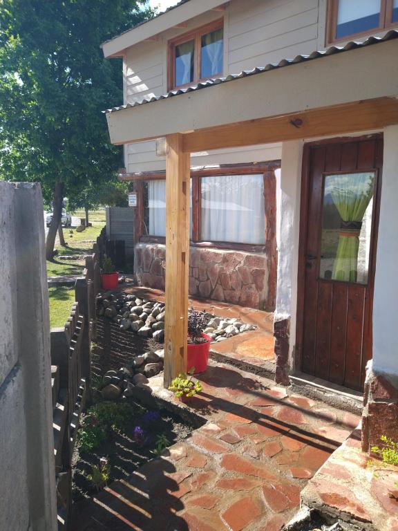 a front entrance to a house with a wooden door at Cabañas Epuyen in Trevelin