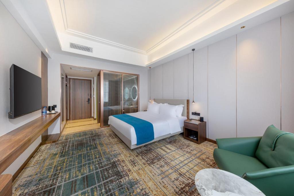 Postel nebo postele na pokoji v ubytování Fortune Land Shenzhen