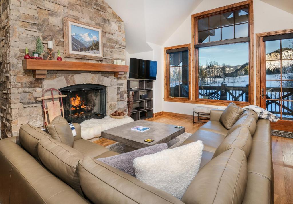 a living room with a couch and a fireplace at Beaver Creek Landing A406 condo in Avon