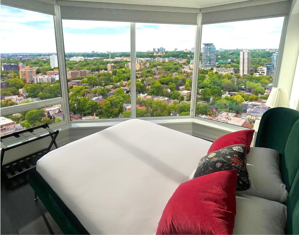 a couch in a room with a large window at Luxury Apartment in Yorkville Downtown Toronto with City View in Toronto