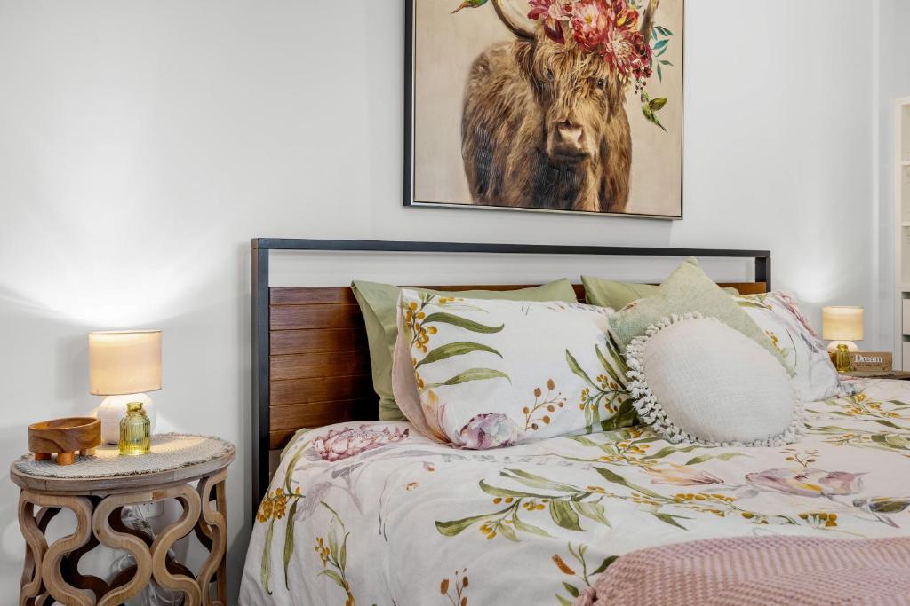 a bedroom with a bed with a picture of a deer at Little Sunshine - Private acreage Guest Home in Hervey Bay