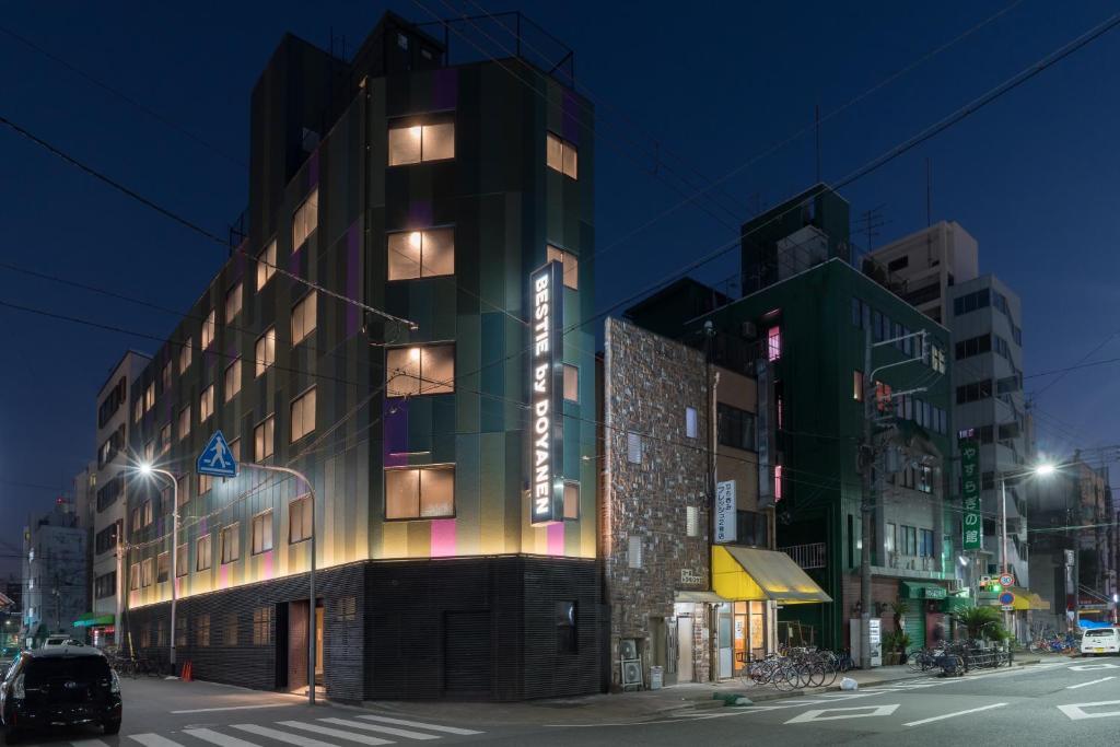 a building on a city street at night at BESTIE by DOYANEN in Osaka