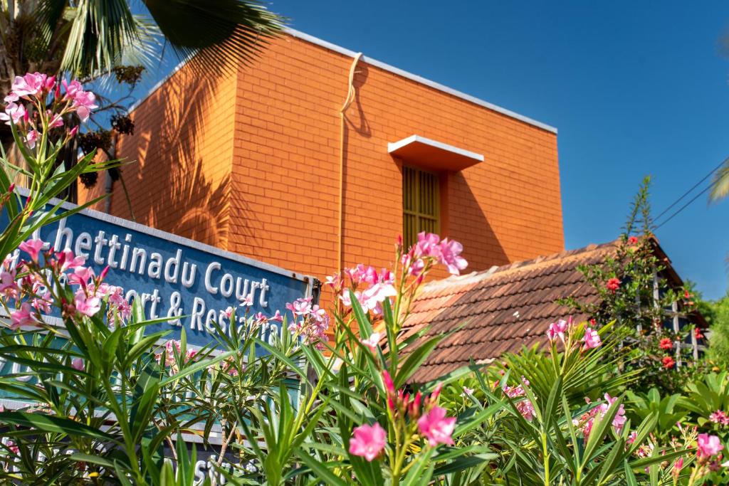 a building with a sign on the side of it at Chettinadu Court- HERITAGE VIEW in Kānādukāttān