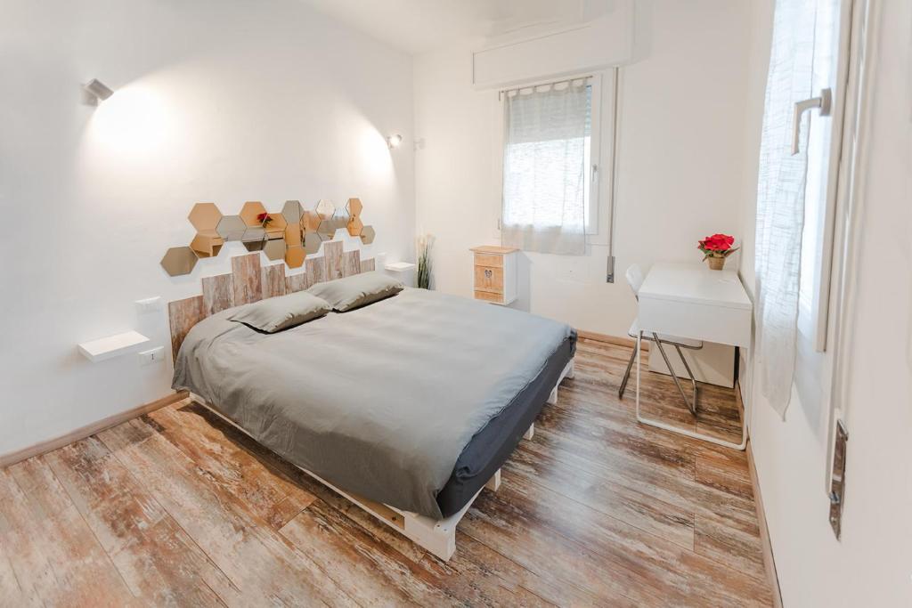 a white bedroom with a bed and a desk at VEry NICE - Cozy Apartment near Venezia Mestre in Mestre