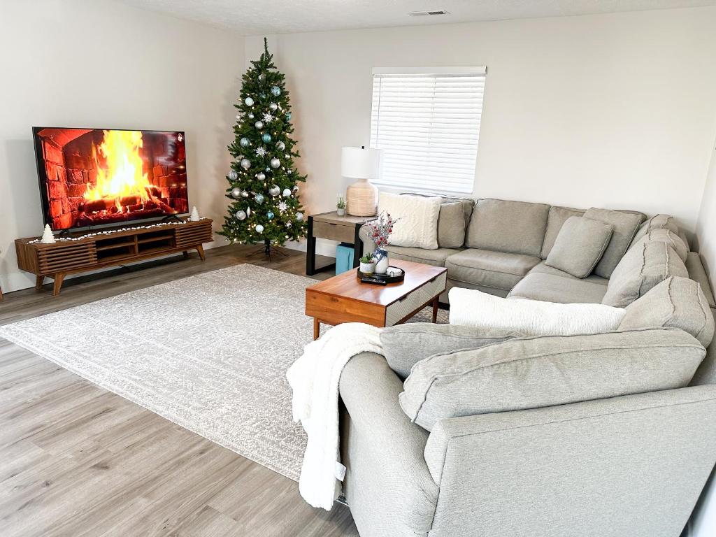 a living room with a couch and a christmas tree at Modern 3 bed 1 bath Home near downtown and UNL Lincoln in Lincoln
