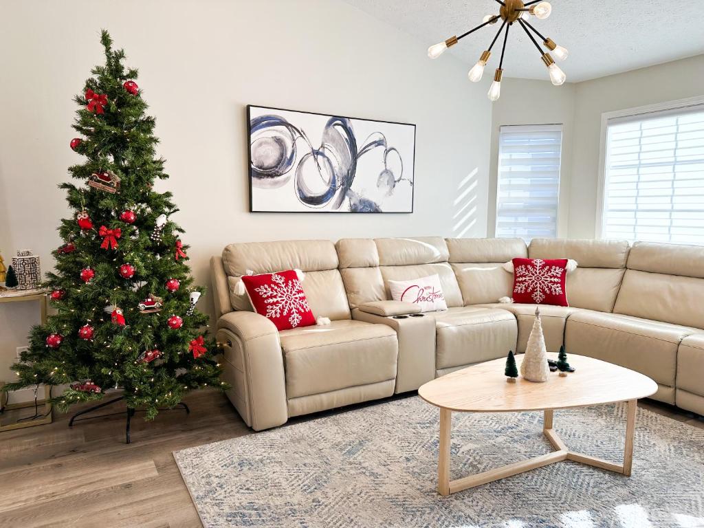 a living room with a christmas tree and a couch at Modern and Spacious Home near downtown and UNL in Lincoln