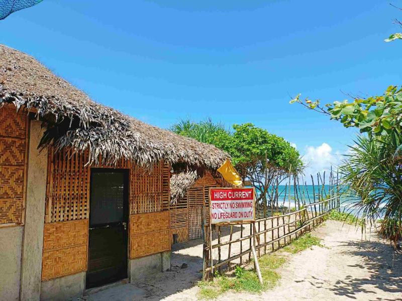 a building with a sign in front of a beach at Dagat-Dagatan Resthouse in Gubat in Gubat