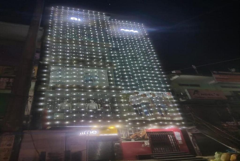 a tall building with lights on it at night at Hotel YLS, Itnagar in Itānagar