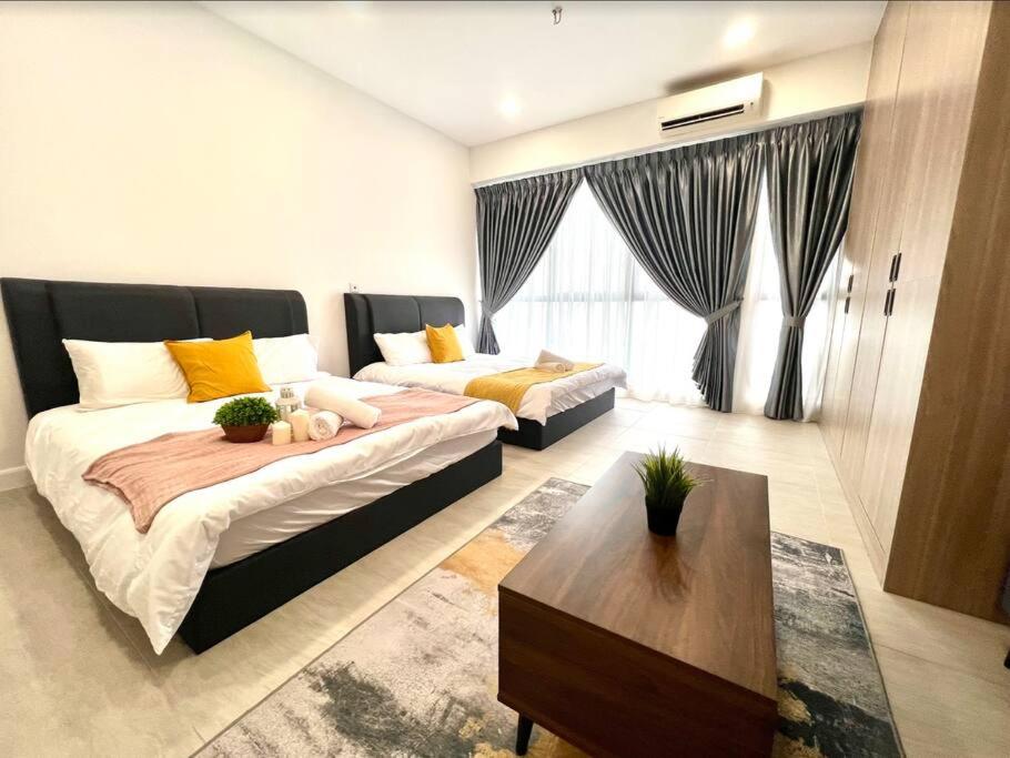 a living room with two beds and a coffee table at 2Bed For 4 // KLIA Sepang Xiamen University in Sepang