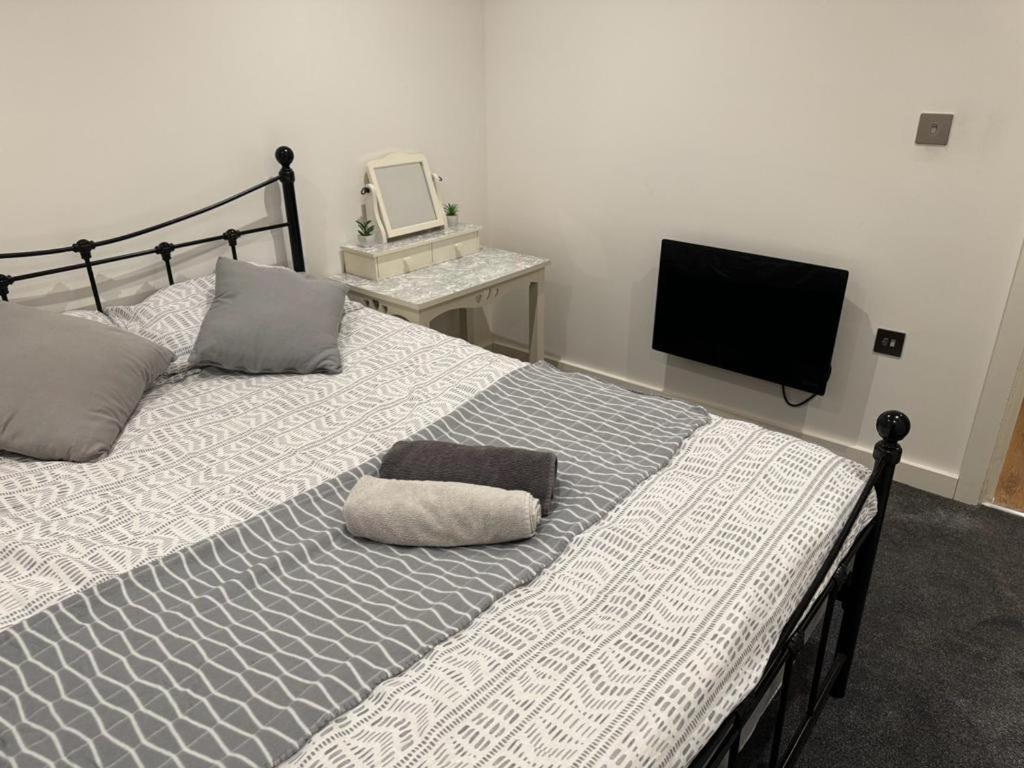 a bedroom with a bed with a pillow on it at Bedroom 3 in Elegant 3 Bed Flat in Ramsgate in Kent