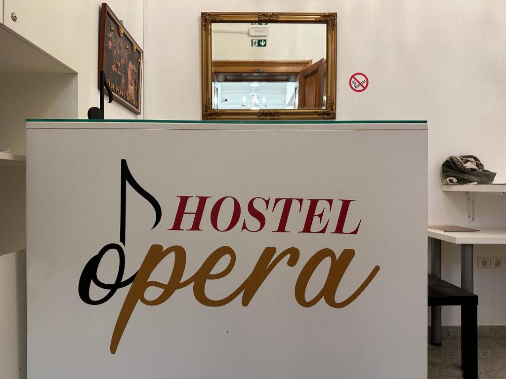 a sign that says hospital opera on a wall at Hostel Opera in Ljubljana