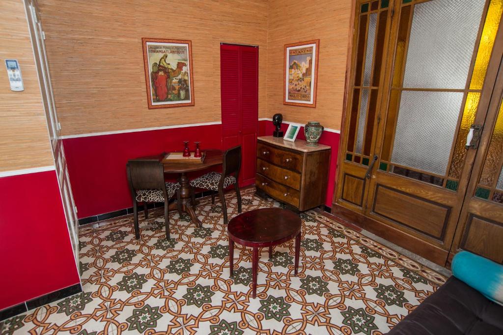 a room with a desk and a table and chairs at La Petite Calanque in Marseille