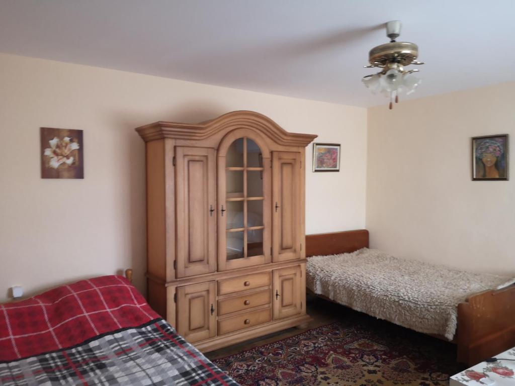 ein Schlafzimmer mit einem großen Holzschrank und einem Bett in der Unterkunft My Levka house 