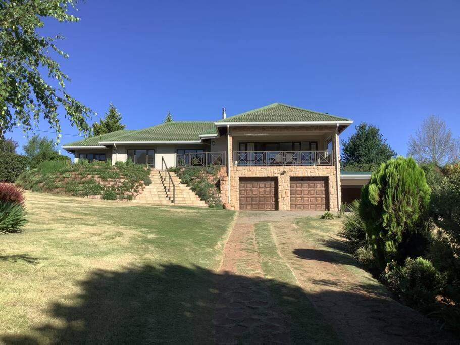 a large brick house with a large yard at The Bell's in the Berg in Underberg