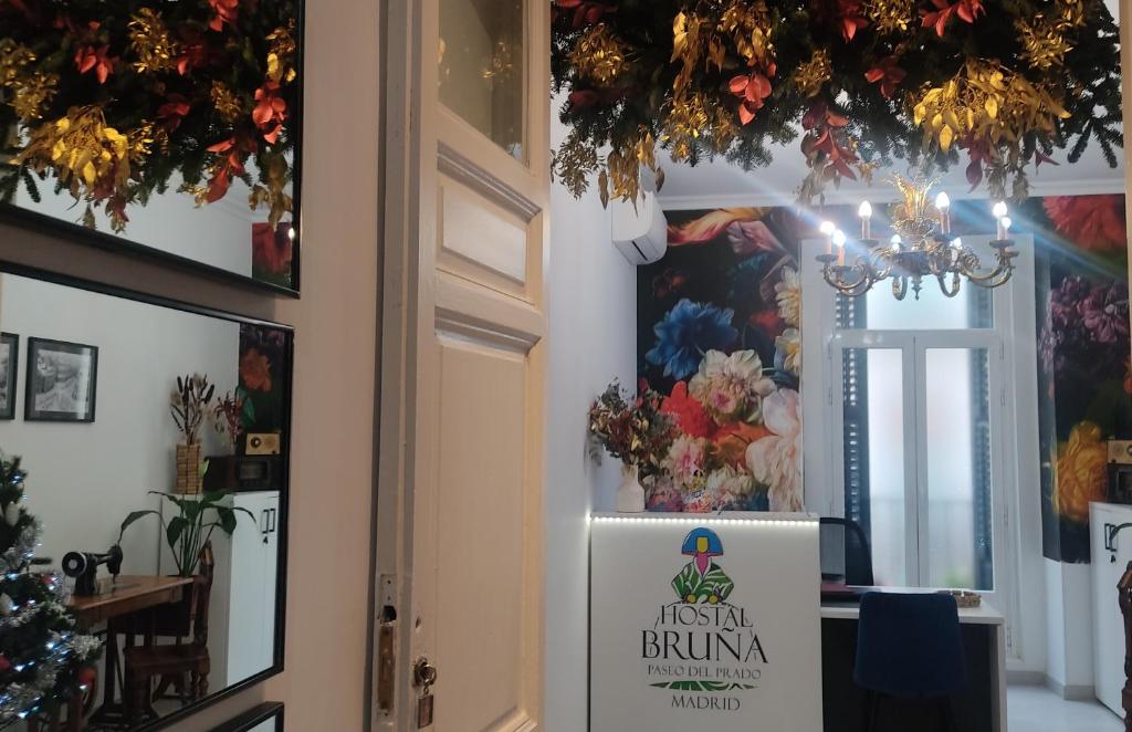 a first class dining room with a sign on the door at Hostal Bruña Paseo del Prado in Madrid