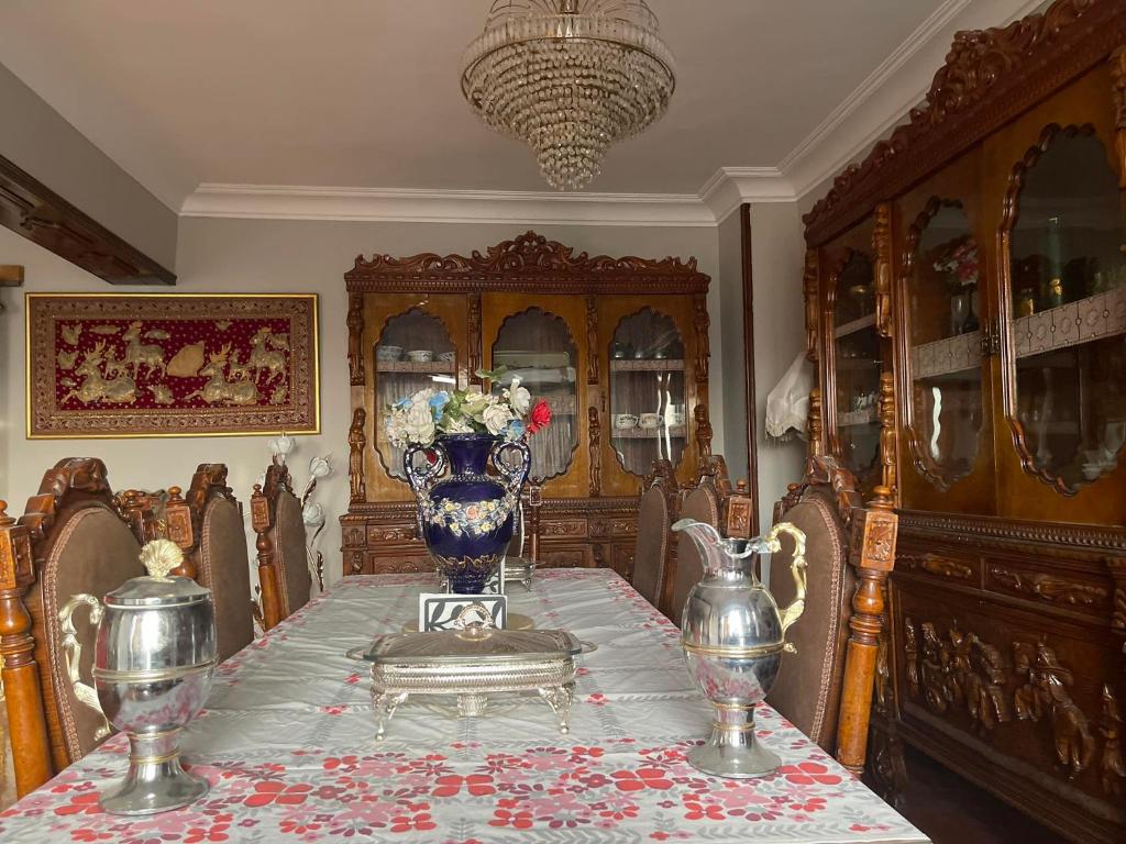 a dining room table with a blue and white vase on it at المهندسين شقه سوبر لوكس - محى الدين ابو العز in Cairo
