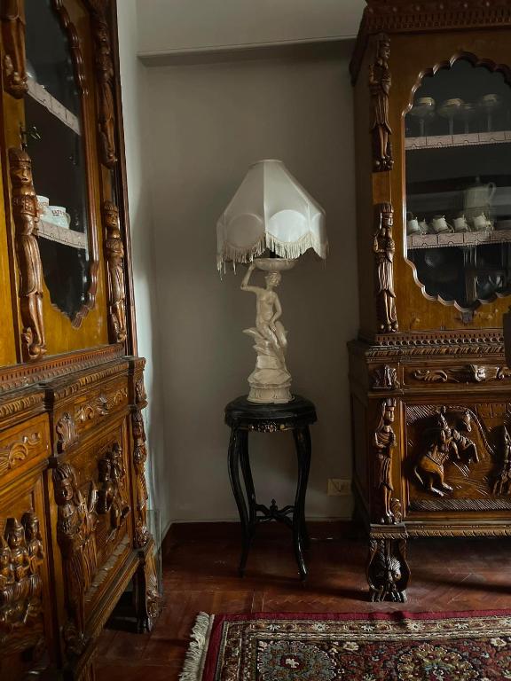 a lamp sitting on a table next to a dresser at المهندسين شقه سوبر لوكس - محى الدين ابو العز in Cairo