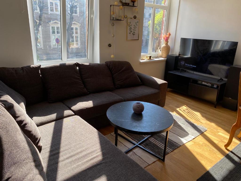 a living room with a couch and a table at Cosy 2 room 55m2 Centric 10min to Old Town AC in Rīga