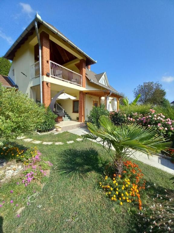 a house with a garden in front of it at Rózsadomb Apartman in Zalakaros