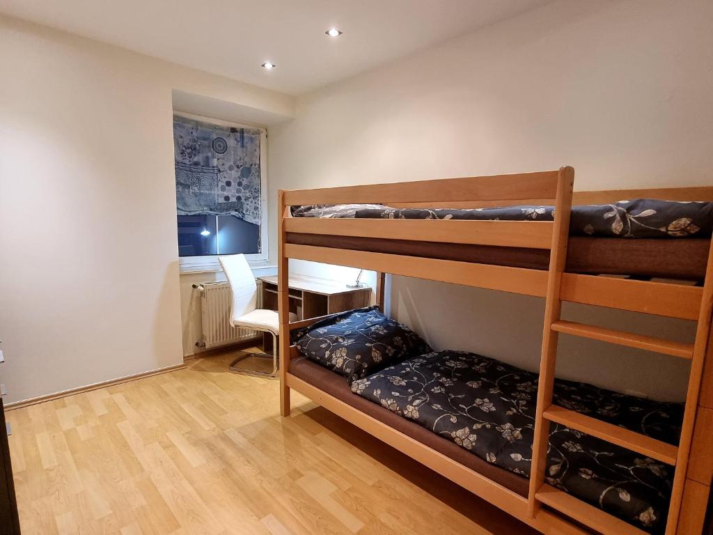 a room with two bunk beds and a desk at Rentcenter79_2 in Sankt Michael in Obersteiermark