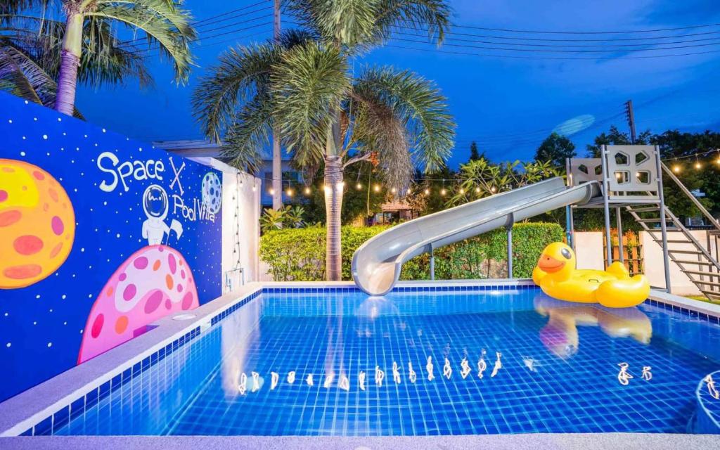 a swimming pool with a slide in a resort at Space X Slider 4 Bedrooms Pool Villa Huahin in Hua Hin