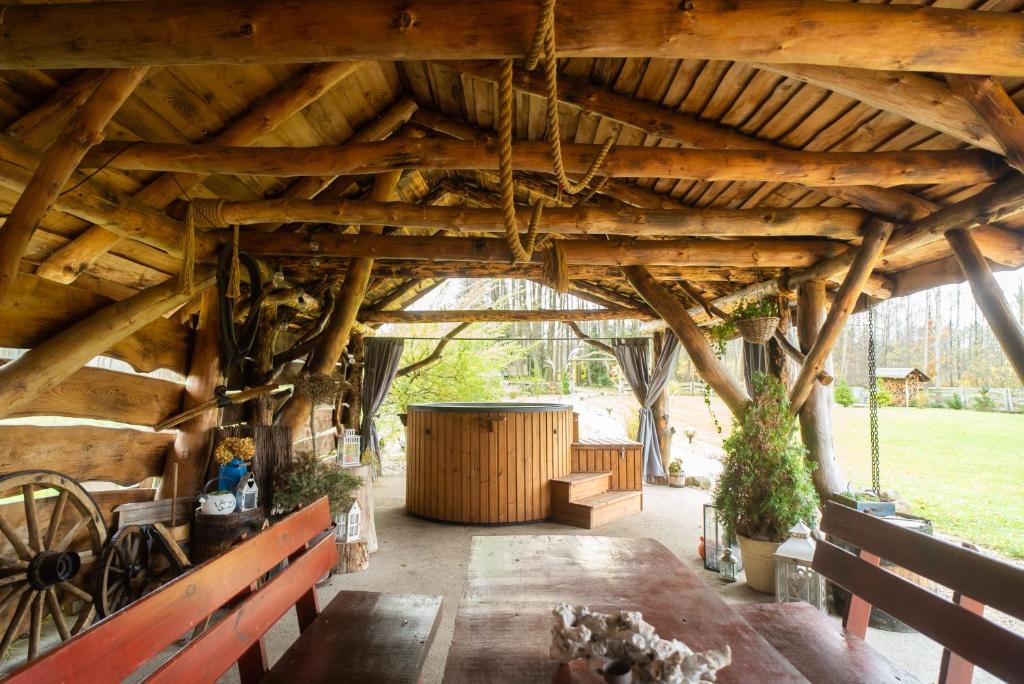 a barn with a wooden ceiling and a wooden table at CHILL Village in Nowinka