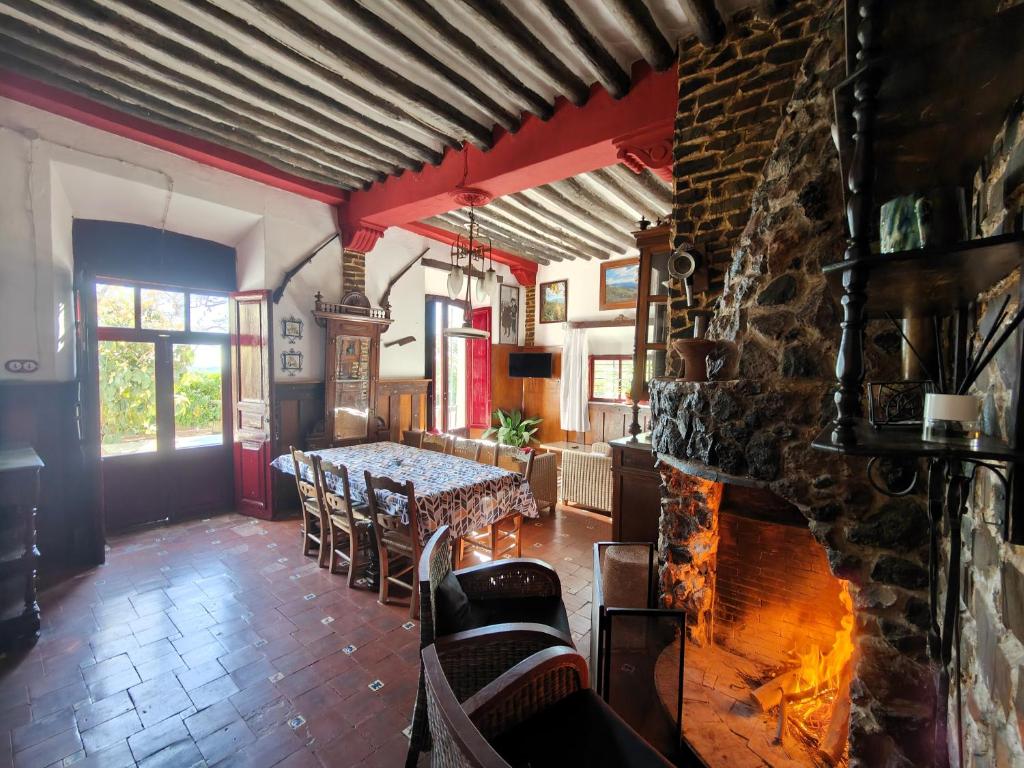 a dining room with a table and a fireplace at Cortijo Buena Vista in Laroles