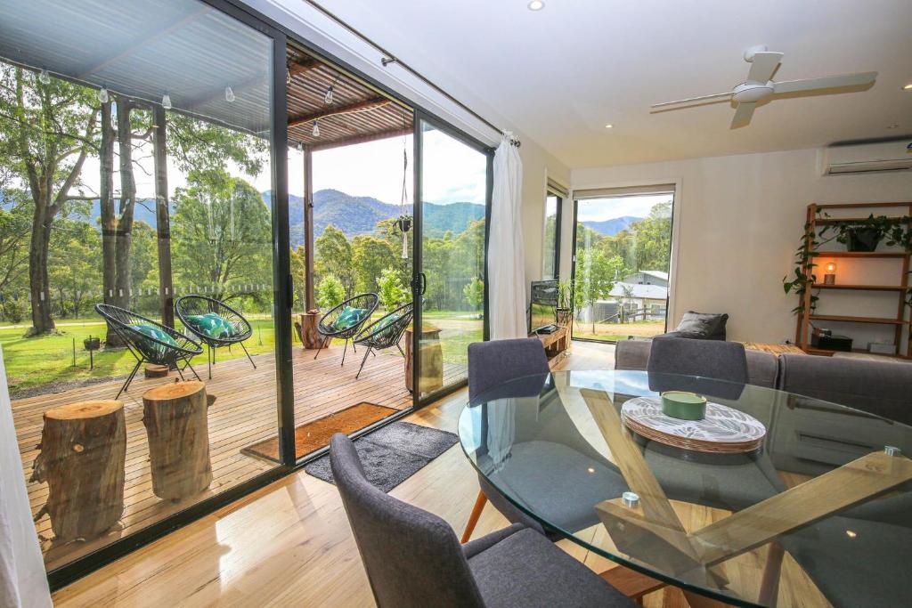 a living room with a glass table and chairs at Ville Views in Harrietville