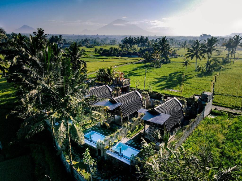 an aerial view of a house with a resort at Alvia Joglo House & Private Pool in Tampaksiring
