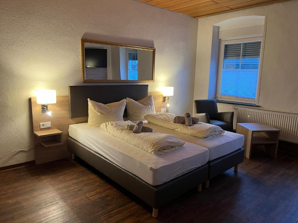 a hotel room with two beds and a mirror at Tilla's Hof in Hamm