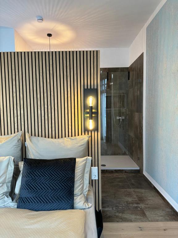 a bedroom with a bed and a shower and a tub at H-36 RESIDENCE 1.1 in Koblenz