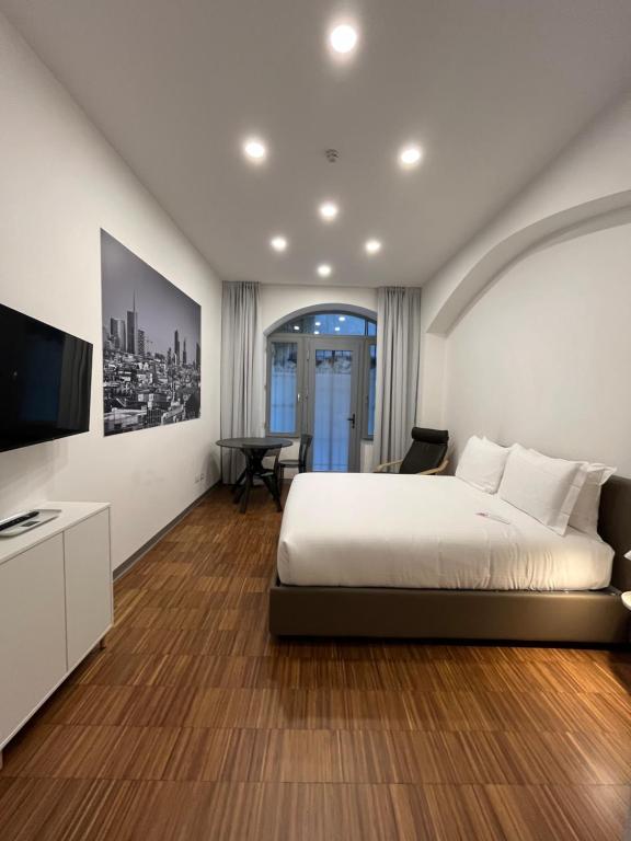 a bedroom with a bed and a flat screen tv at MiAp ORTI 31 in Milan