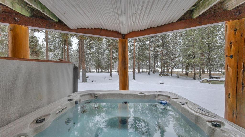 a jacuzzi tub in a cabin in the snow at Crane - Unit 6 in Bend