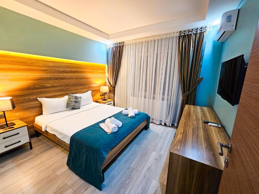 Sapanca Resort Hotel في ساكاريا: غرفة فندق عليها سرير وفوط