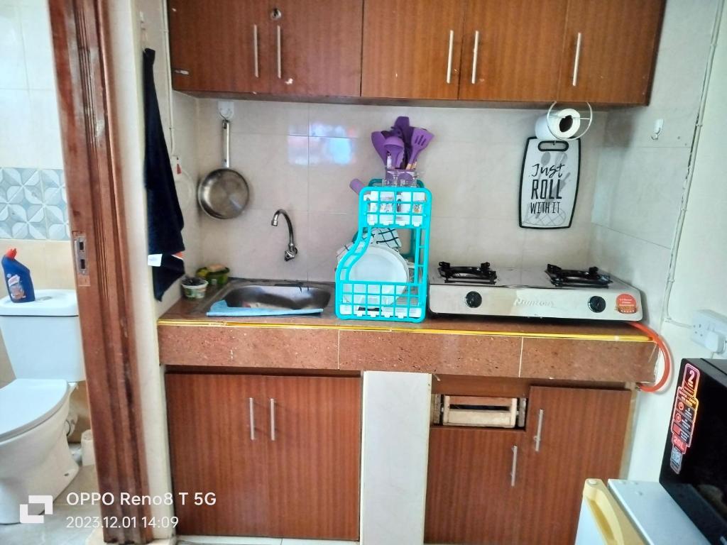 a kitchen with a sink and a bottle on a counter at Gulf breeze heritage in Ruiru