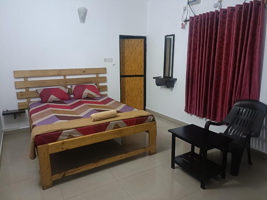 a bedroom with a wooden bed and a chair at Hotel Khushi Waves in Arpora