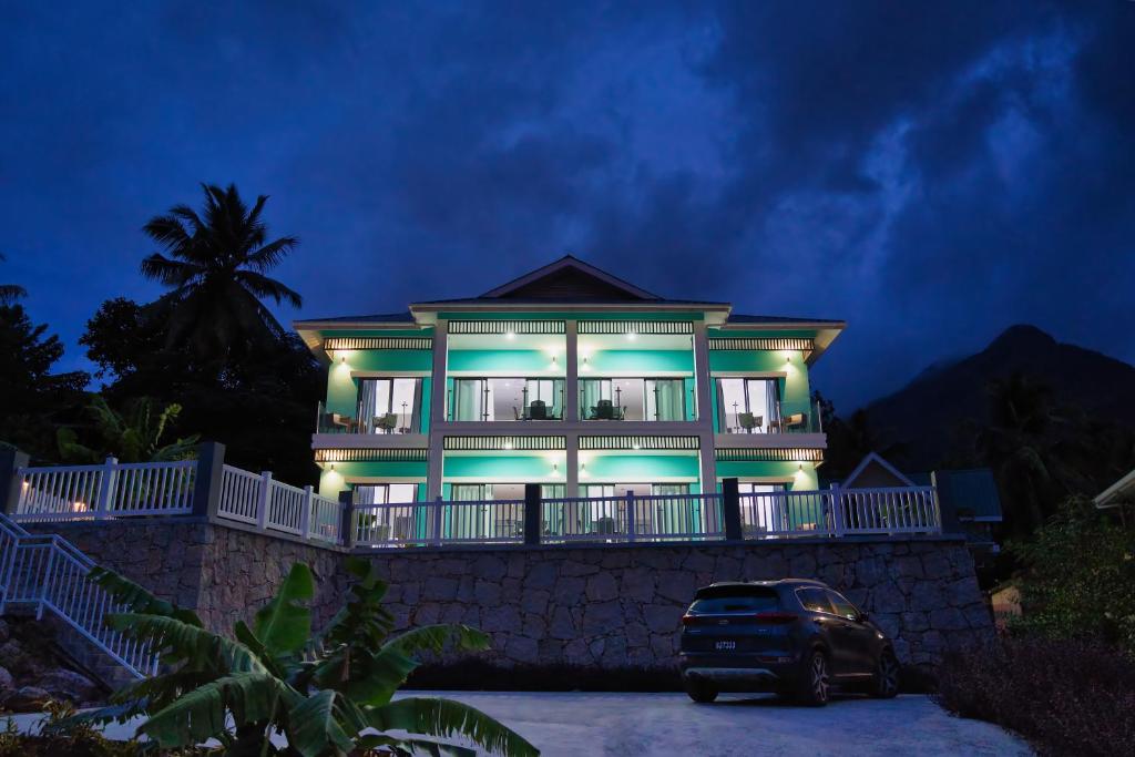 a house with a car parked in front of it at Sunset Haven Villa in Beau Vallon
