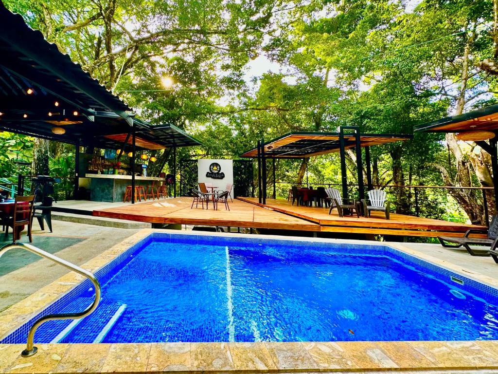 a swimming pool with a pavilion and a house at Jungle Beach Hotel Manuel Antonio in Manuel Antonio