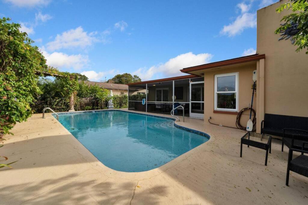 a swimming pool in the backyard of a house at Stunning 3BR Home offers water view Minutes to the Beach in Clearwater