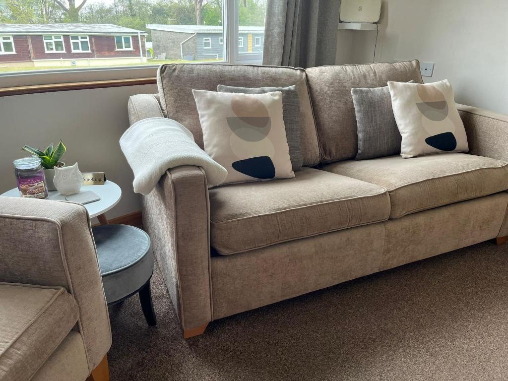 a living room with a couch and a window at Idyllic Entire Chalet in Bideford Bay holiday Park near Clovelly in Bideford